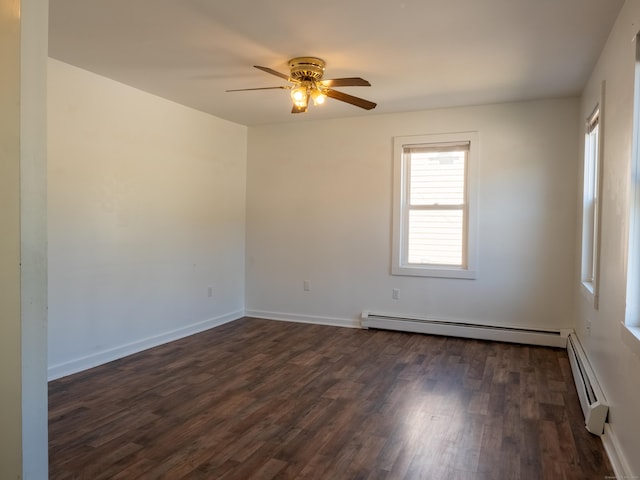 empty room featuring dark wood-type flooring, a ceiling fan, baseboards, and baseboard heating