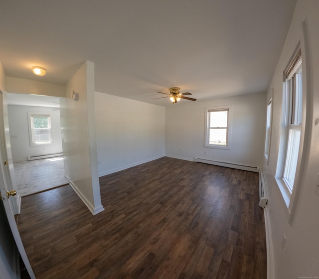 spare room with ceiling fan, dark wood finished floors, baseboards, and a baseboard radiator