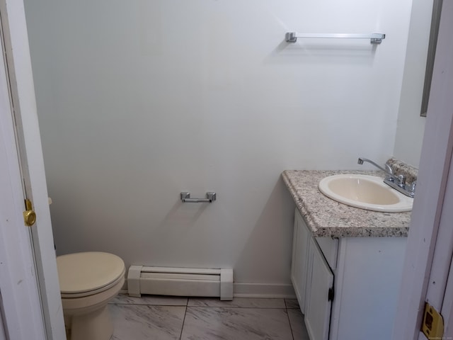 bathroom with baseboard heating, vanity, toilet, marble finish floor, and baseboards