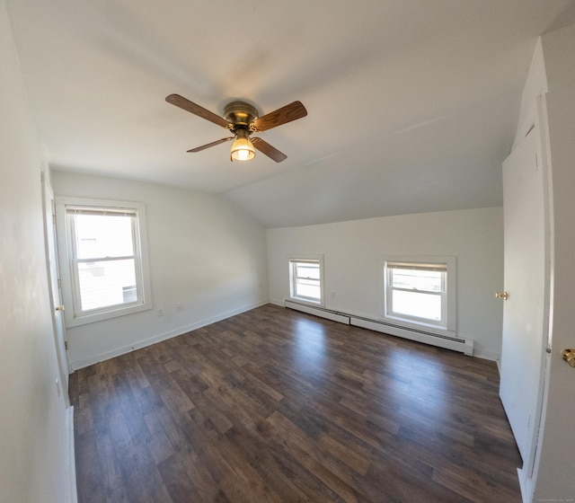 bonus room with ceiling fan, a baseboard heating unit, wood finished floors, and vaulted ceiling