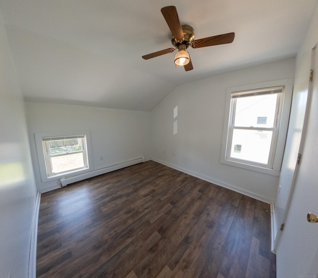 additional living space with dark wood-style flooring, lofted ceiling, baseboards, ceiling fan, and a baseboard heating unit