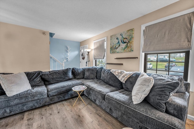 living room with a textured ceiling and wood finished floors