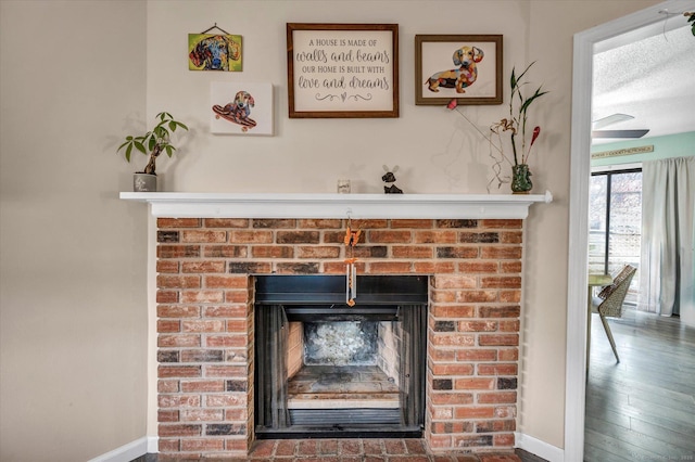 room details with baseboards, a fireplace, and wood finished floors