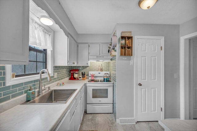 kitchen featuring a sink, white electric stove, under cabinet range hood, marble finish floor, and white cabinets