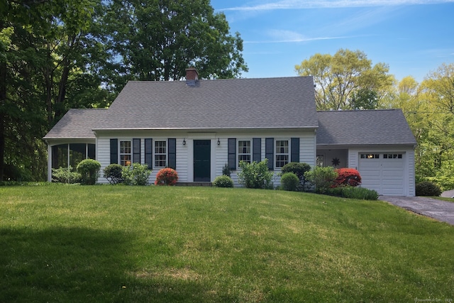 cape cod home featuring aphalt driveway, a front lawn, an attached garage, a chimney, and a shingled roof