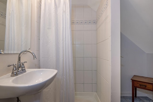 bathroom featuring a sink and curtained shower