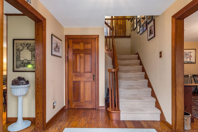 stairs featuring baseboards and hardwood / wood-style flooring