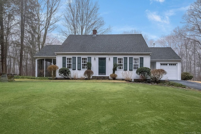 cape cod-style house with a front yard, an attached garage, driveway, and roof with shingles