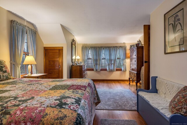 bedroom with wood finished floors and baseboards