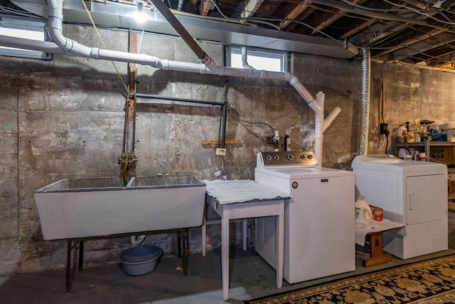 unfinished basement featuring a sink and washer and clothes dryer