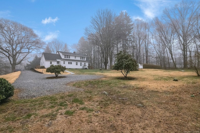 exterior space with a chimney and a front lawn