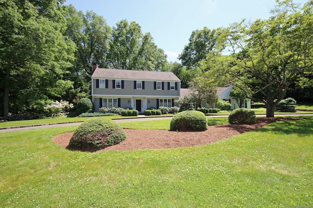 125 Silver Spring Rd, Fairfield, CT 06824 - colonial-style house featuring a chimney and a front lawn