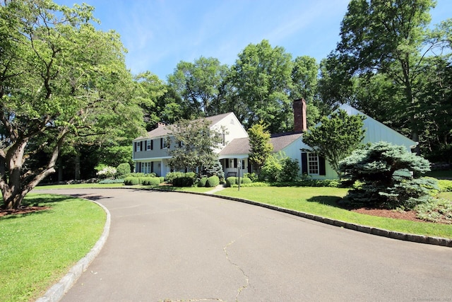 125 Silver Spring Rd, Fairfield, CT 06824 - view of front of home featuring a chimney, a front lawn, and driveway
