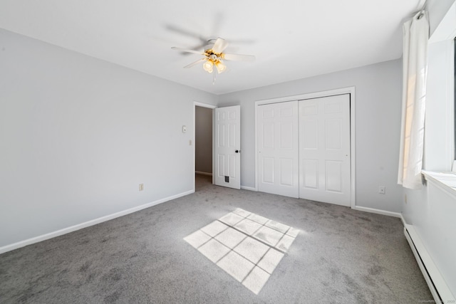 unfurnished bedroom with a closet, a baseboard radiator, carpet flooring, and baseboards