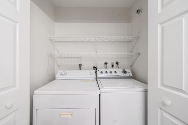 clothes washing area featuring washer and dryer and laundry area