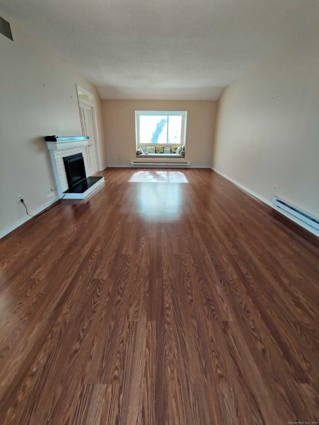 unfurnished living room with a fireplace and dark wood finished floors