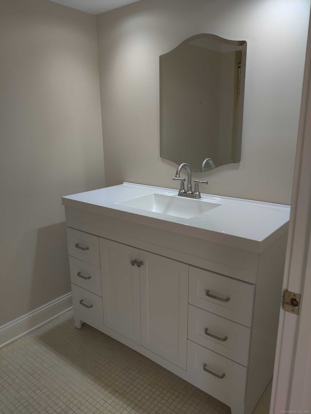 bathroom featuring baseboards, tile patterned flooring, and vanity