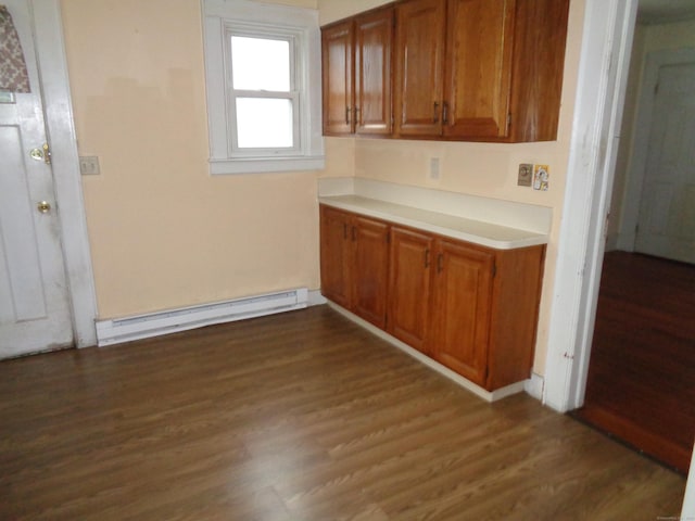426 Courtland Ave Apt 1, Stamford, CT 06906 - kitchen featuring baseboard heating, dark wood-style flooring, brown cabinets, and light countertops