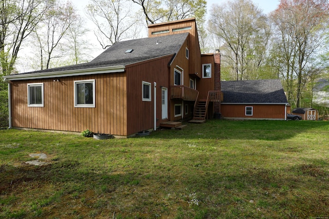 953 Rainbow Trl, Orange, CT 06477 - rear view of property with stairway, a shingled roof, a chimney, a lawn, and a deck