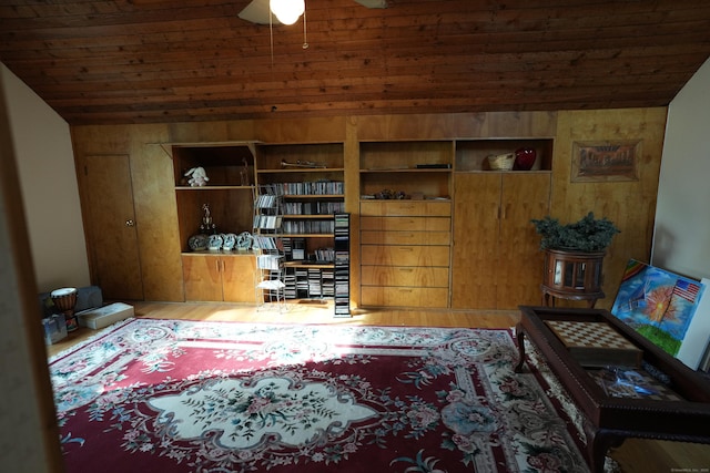 953 Rainbow Trl, Orange, CT 06477 - sitting room with wooden ceiling, wood walls, vaulted ceiling, a ceiling fan, and wood finished floors