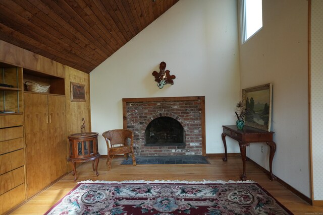953 Rainbow Trl, Orange, CT 06477 - living area with high vaulted ceiling, wood finished floors, a fireplace, and wood ceiling