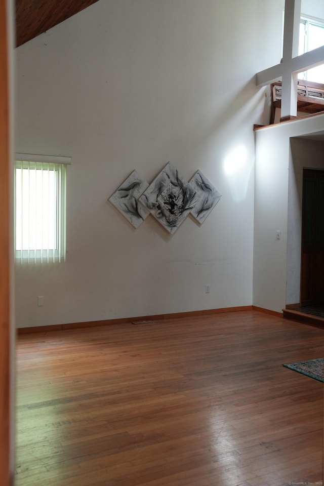 953 Rainbow Trl, Orange, CT 06477 - spare room featuring plenty of natural light, wood finished floors, vaulted ceiling, and baseboards