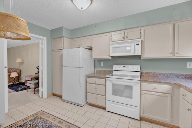 kitchen featuring white appliances, a textured ceiling, and light tile patterned floors