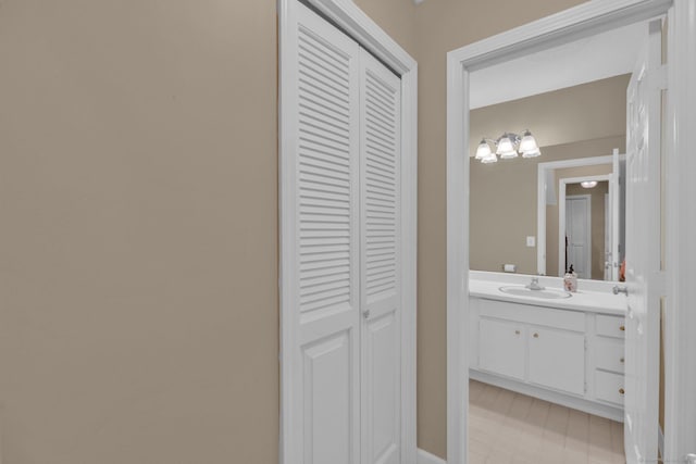 bathroom featuring vanity and a closet