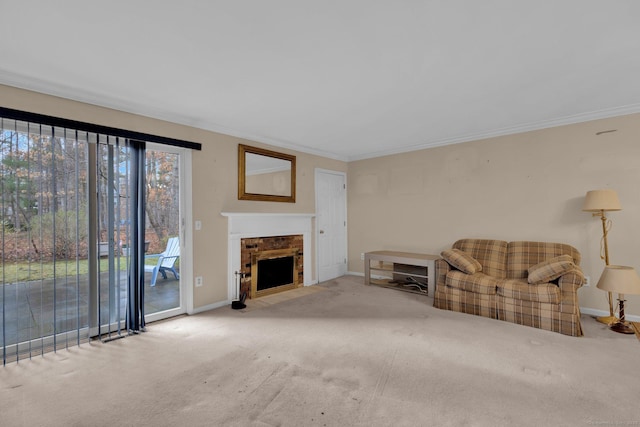 carpeted living area with a fireplace with flush hearth, baseboards, and ornamental molding