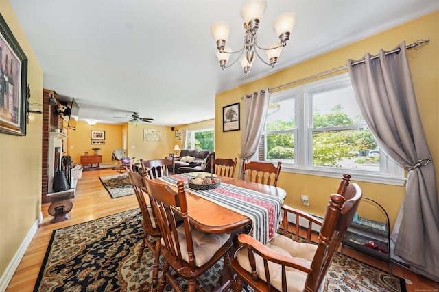 17 Straitsville Rd, Prospect, CT 06712 - dining space with wood finished floors, a chandelier, baseboards, ceiling fan, and a brick fireplace