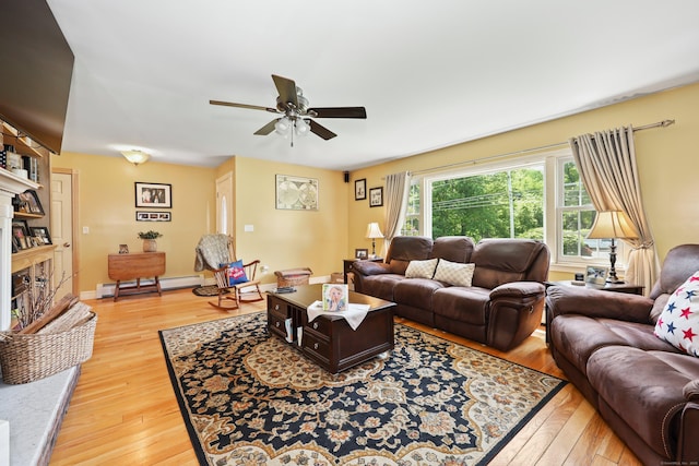 17 Straitsville Rd, Prospect, CT 06712 - living room with baseboard heating, light wood finished floors, ceiling fan, and a fireplace with raised hearth