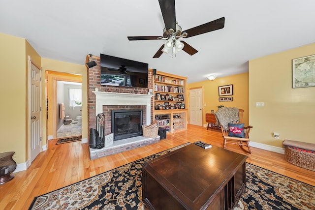 17 Straitsville Rd, Prospect, CT 06712 - living area with hardwood / wood-style flooring, a brick fireplace, a ceiling fan, and baseboards