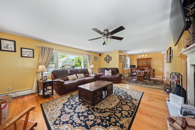 17 Straitsville Rd, Prospect, CT 06712 - living room featuring a baseboard radiator, hardwood / wood-style floors, a ceiling fan, a chandelier, and a fireplace