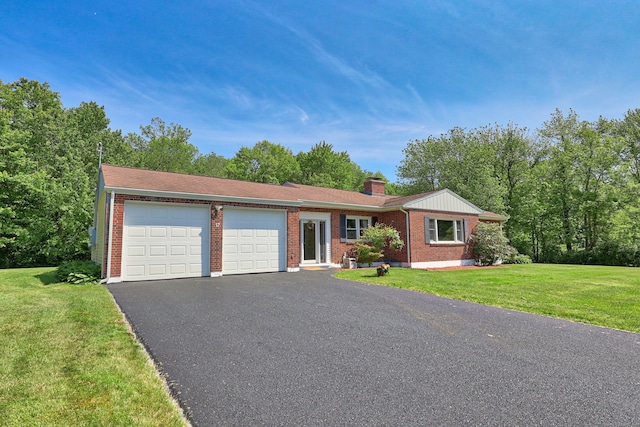 17 Straitsville Rd, Prospect, CT 06712 - view of front of house with an attached garage, asphalt driveway, brick siding, a chimney, and a front lawn
