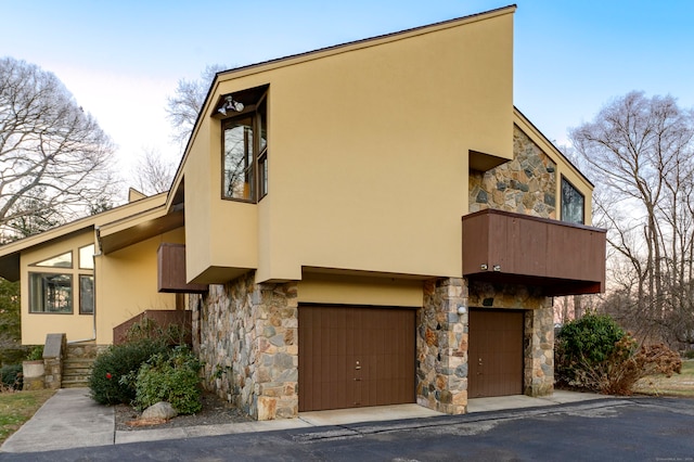 41 Seeley Rd, Trumbull, CT 06611 - view of front of house with stone siding, stucco siding, a balcony, and a garage