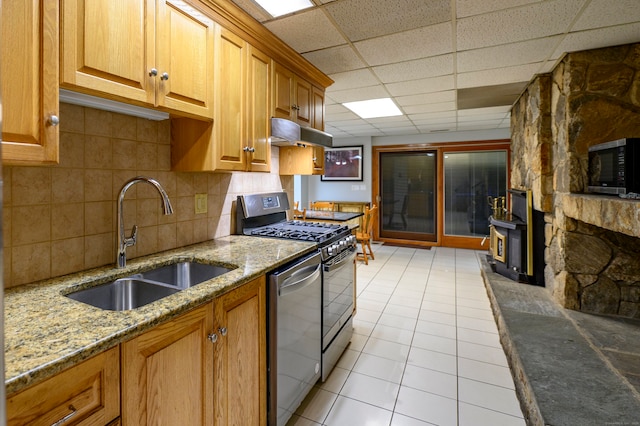 41 Seeley Rd, Trumbull, CT 06611 - kitchen with stainless steel appliances, a paneled ceiling, under cabinet range hood, light stone counters, and brown cabinets