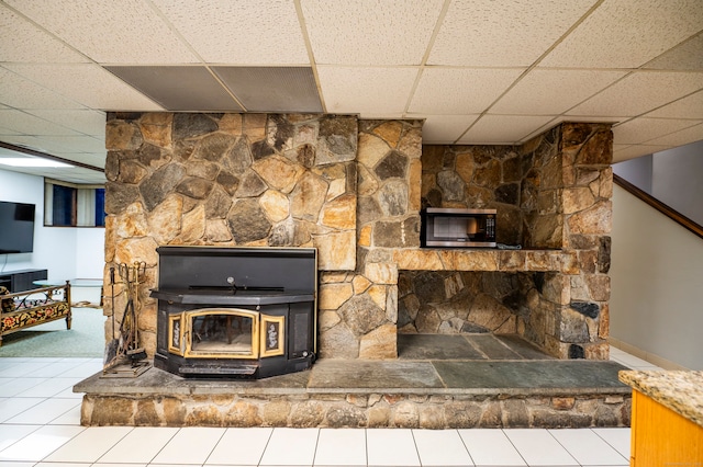 41 Seeley Rd, Trumbull, CT 06611 - detailed view of stainless steel microwave, a drop ceiling, a wood stove, and carpet flooring