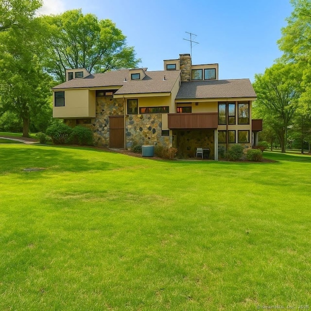 41 Seeley Rd, Trumbull, CT 06611 - back of property featuring stone siding, a lawn, and a chimney
