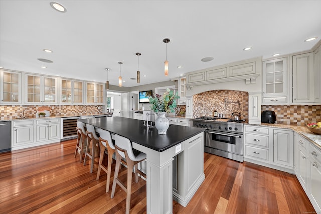 65 Joes Hill Rd, Danbury, CT 06811 - kitchen with appliances with stainless steel finishes, beverage cooler, tasteful backsplash, a center island, and light wood-type flooring