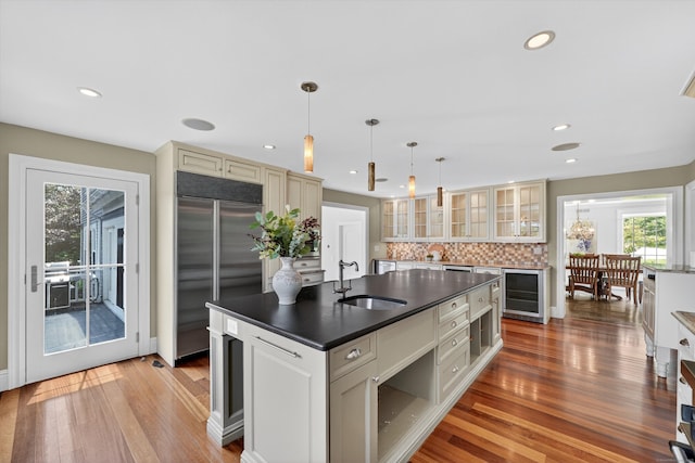 65 Joes Hill Rd, Danbury, CT 06811 - kitchen with built in refrigerator, beverage cooler, light wood-type flooring, dark countertops, and backsplash