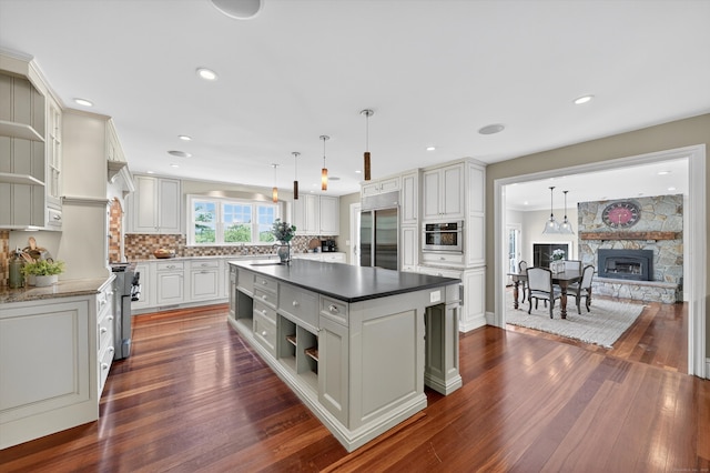 65 Joes Hill Rd, Danbury, CT 06811 - kitchen with open shelves, appliances with stainless steel finishes, dark wood-style floors, backsplash, and a center island