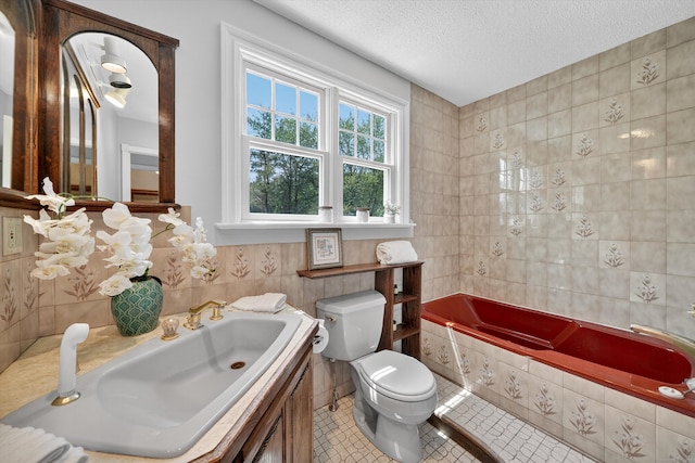 65 Joes Hill Rd, Danbury, CT 06811 - full bath featuring tile walls, a relaxing tiled tub, a textured ceiling, vanity, and tile patterned flooring