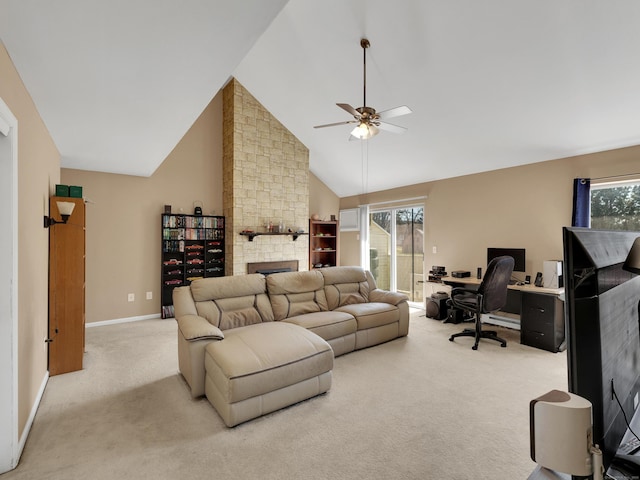 carpeted living area with a stone fireplace, high vaulted ceiling, baseboards, and ceiling fan
