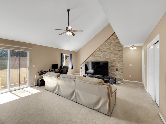living area with light carpet, a wealth of natural light, baseboards, and a ceiling fan