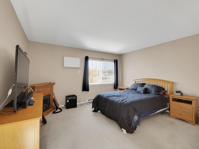 carpeted bedroom with baseboards and a baseboard heating unit