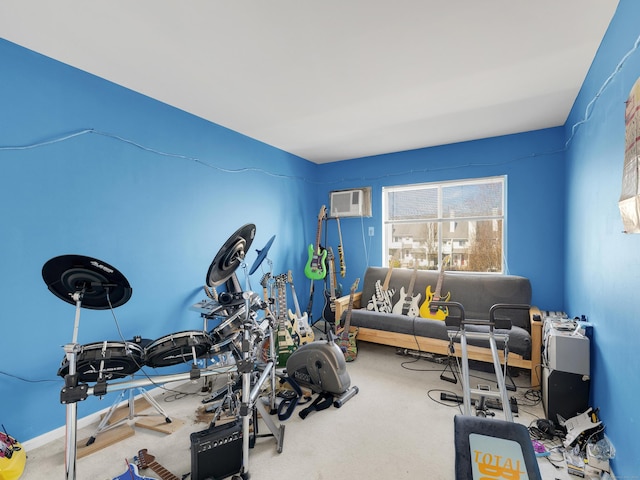 exercise room featuring a wall mounted AC and carpet