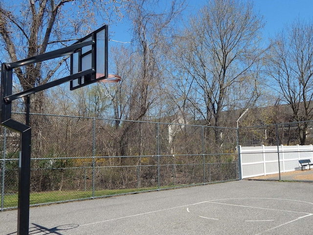 view of basketball court featuring community basketball court and fence