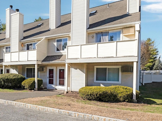 exterior space featuring a balcony and a chimney