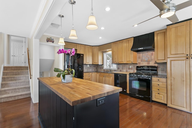 kitchen featuring range hood, visible vents, a sink, black appliances, and butcher block countertops