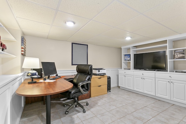 office with a paneled ceiling, recessed lighting, a wainscoted wall, and light tile patterned floors